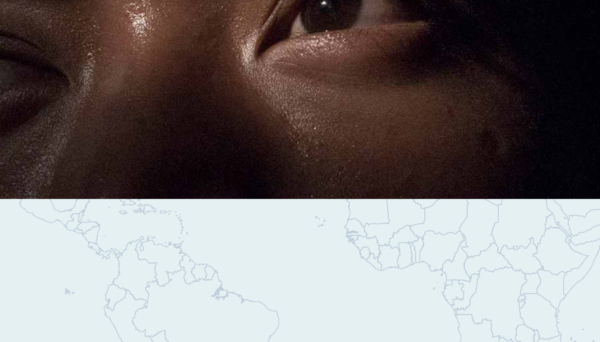eyes of a person over a map of the world