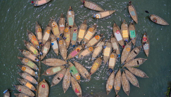 Aerial view of traditional fishing boats along Buriganga river in Keraniganj, Dhaka, Bangladesh.